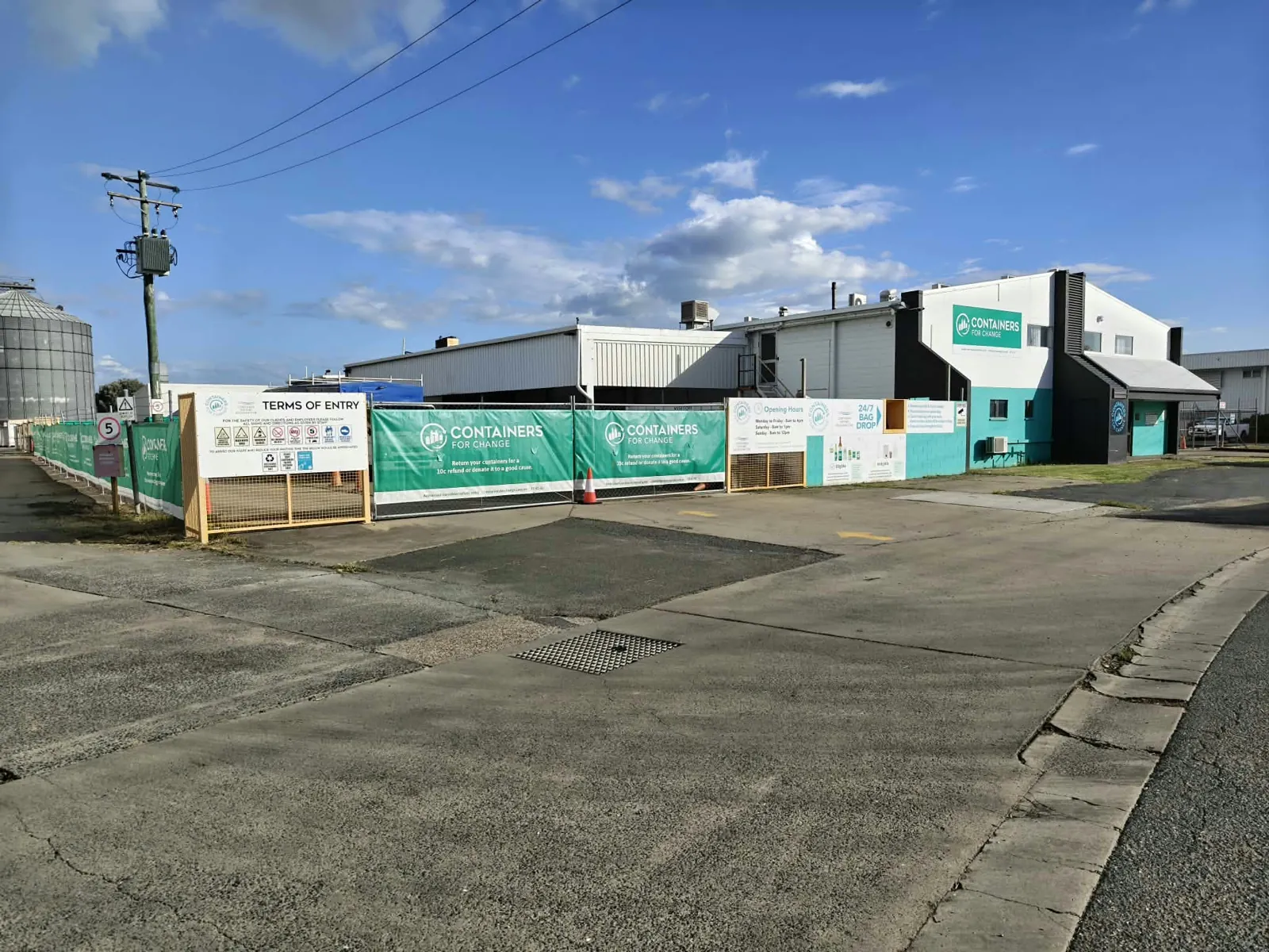 The Park Avenue depot on Dooley Street, with its green Containers for Change fence and signs
