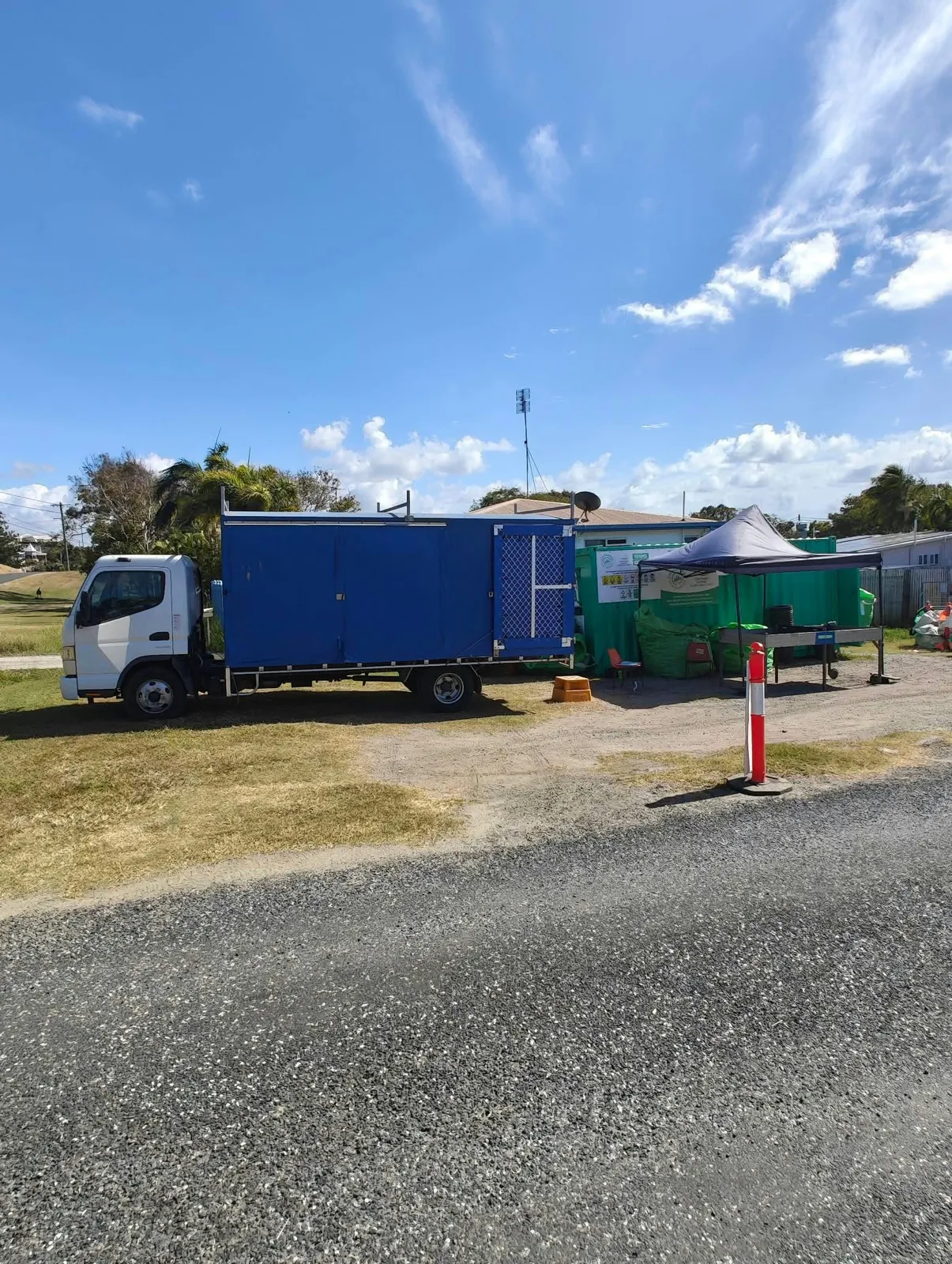 The Emu Park pop-up, a truck and green Containers for Change bins beside the road